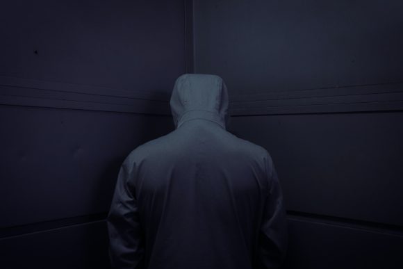 man in gray hoodie standing